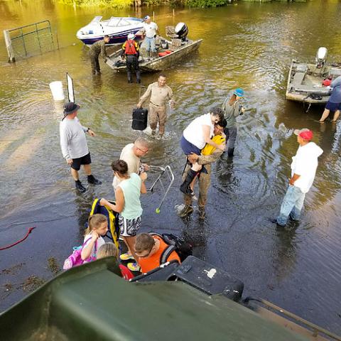 Rescuers evacuate people during a flood.